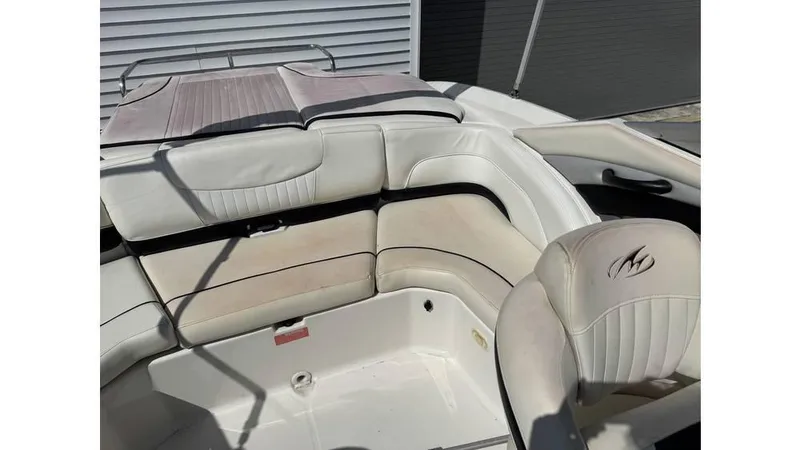 Slide: The Image of 2007 Monterey 234FS boat interior with white leather seating and logo. - 8