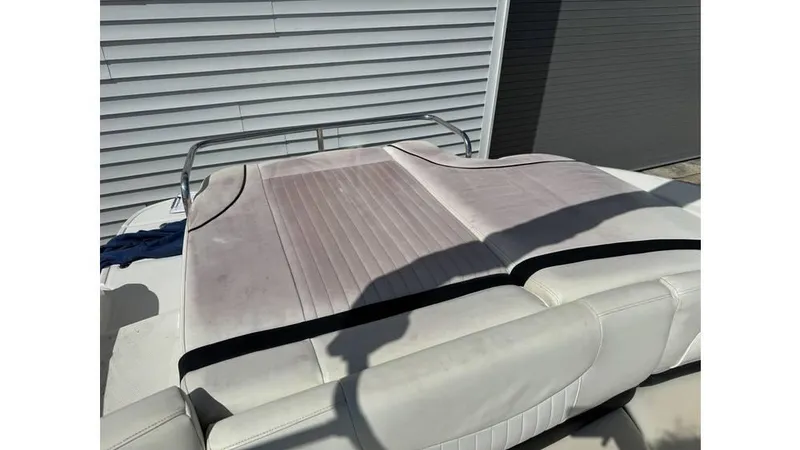 Slide: The Image of 2007 Monterey 234FS boat seat with light upholstery and metal railing. - 9