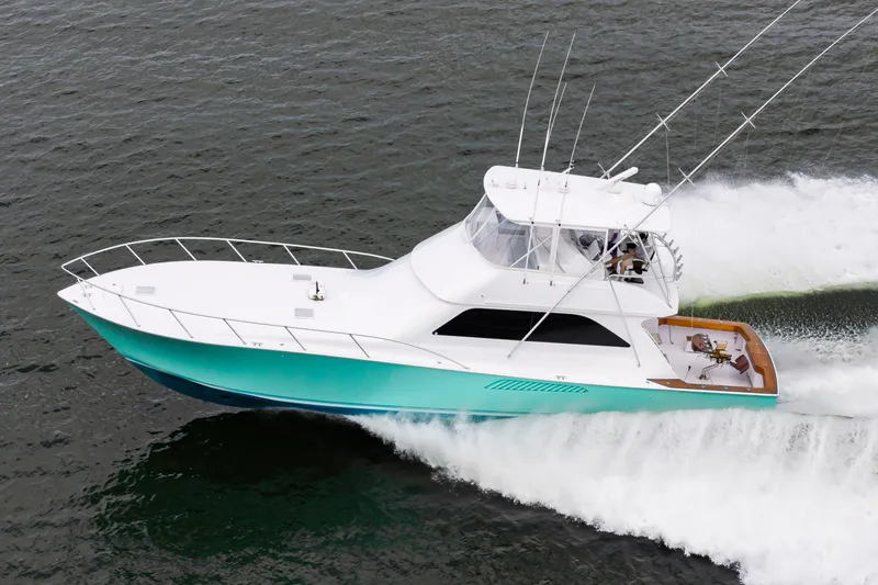 Slide: The Image of 2003 Viking 61 Convertible yacht cruising on open water. - 1