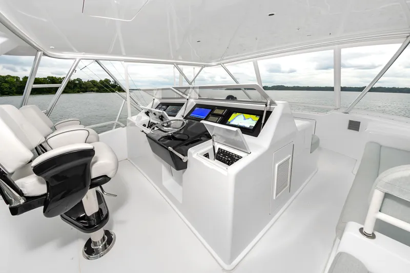 Slide: The Image of 2003 Viking 61 Convertible yacht helm with modern navigation equipment and luxurious seating. - 11