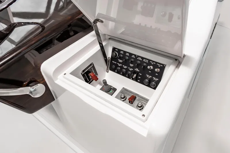 Slide: The Image of Control panel of a 2003 Viking 61 Convertible yacht, featuring switches and levers. - 16