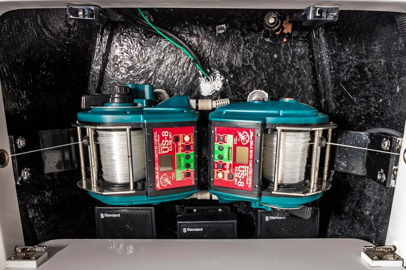 Slide: The Image of Fishing reel setup inside 2003 Viking 61 Convertible boat, featuring electric line spools. - 18