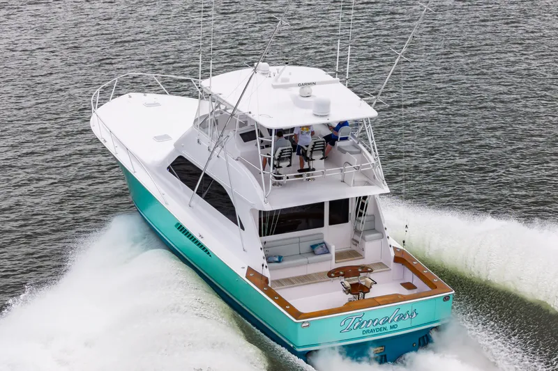 Slide: The Image of 2003 Viking 61 Convertible yacht cruising on open water. - 2