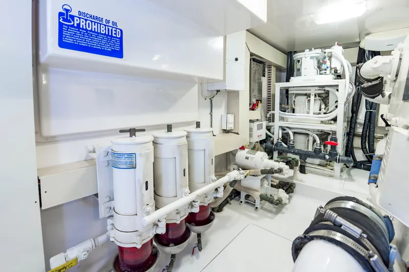 Slide: The Image of Engine room of 2003 Viking 61 Convertible yacht with oil discharge warning sign. - 35