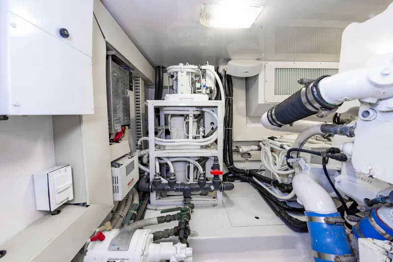 Slide: The Image of Engine room of 2003 Viking 61 Convertible yacht, showcasing complex machinery and piping. - 38