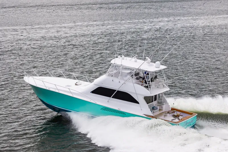 Slide: The Image of 2003 Viking 61 Convertible yacht cruising on open water. - 4