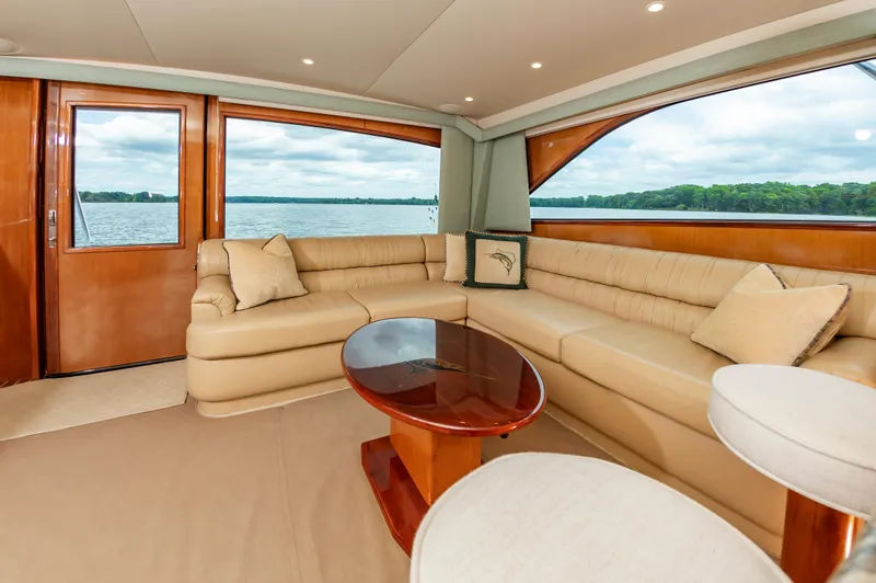 Slide: The Image of Luxurious interior of 2003 Viking 61 Convertible yacht with beige seating and wooden accents. - 42