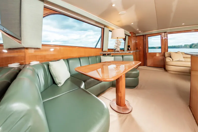 Slide: The Image of Luxurious interior of 2003 Viking 61 Convertible yacht with green leather seating. - 44