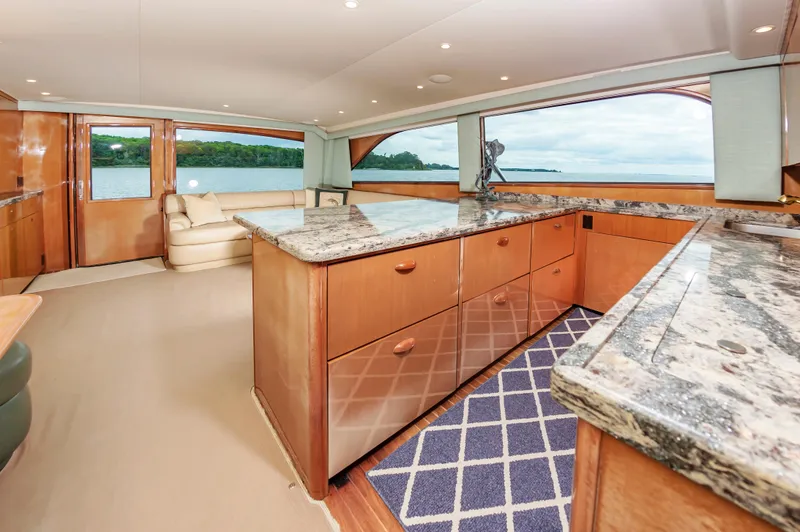 Slide: The Image of Luxurious interior of 2003 Viking 61 Convertible yacht with granite countertops and scenic views. - 48