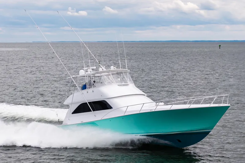 Slide: The Image of 2003 Viking 61 Convertible yacht cruising on open water. - 5