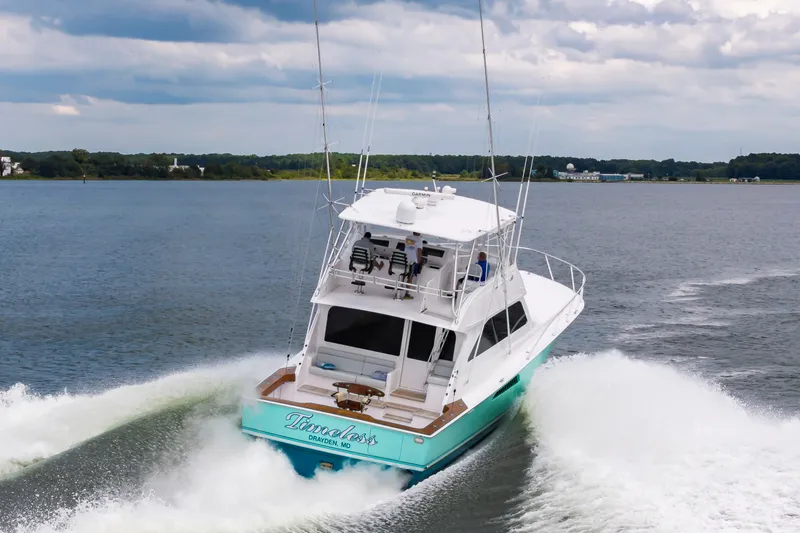 Slide: The Image of 2003 Viking 61 Convertible yacht cruising on open water. - 8