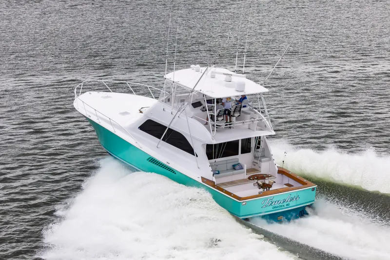 Slide: The Image of 2003 Viking 61 Convertible yacht cruising on open water. - 9