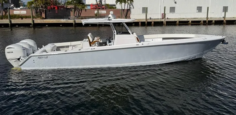Slide: The Image of 2025 Jupiter 380LS boat on water, featuring sleek design and twin Yamaha engines. - 0