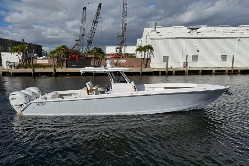 Slide: The Image of 2025 Jupiter 380LS boat on water, industrial background, cloudy sky. - 1