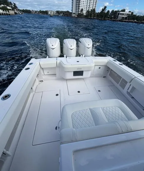 Slide: The Image of 2025 Jupiter 380LS boat with triple engines cruising on a scenic waterway. - 10