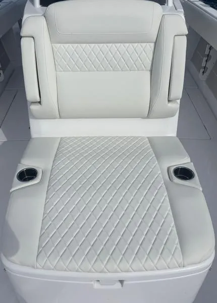 Slide: The Image of Luxurious seating on 2025 Jupiter 380LS boat with diamond-stitched upholstery and cup holders. - 11