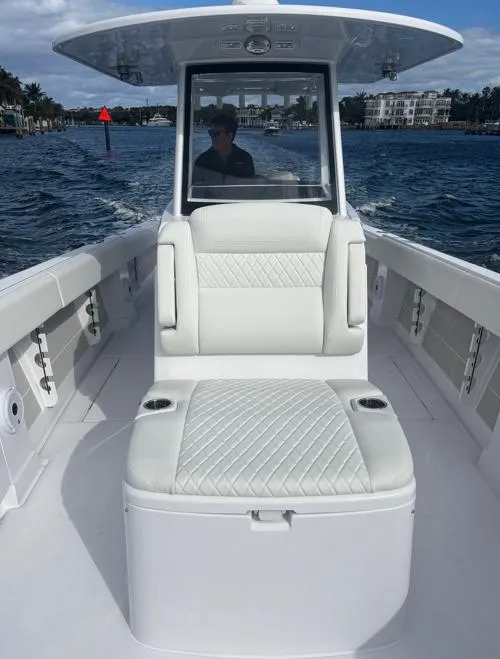 Slide: The Image of 2025 Jupiter 380LS boat interior with white seating, cruising on a sunny day. - 12