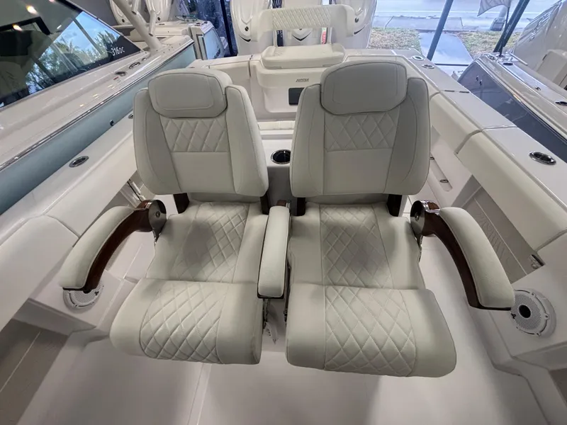 Slide: The Image of Luxurious seating on 2025 Jupiter 380LS boat with quilted upholstery and armrests. - 13