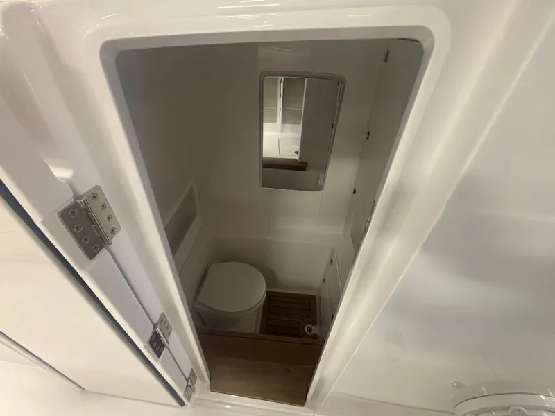Slide: The Image of Compact bathroom in 2025 Jupiter 380LS boat with toilet and mirror. - 18