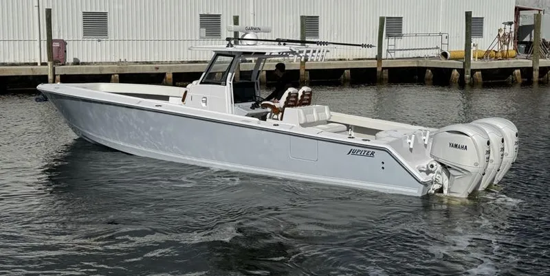 Slide: The Image of 2025 Jupiter 380LS boat with triple Yamaha engines docked in marina. - 4