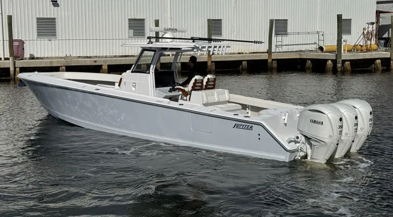 Slide: The Image of 2025 Jupiter 380LS boat with triple Yamaha engines docked in marina. - 5