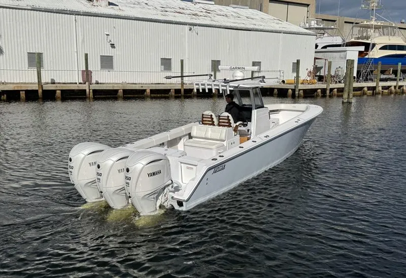 Slide: The Image of 2025 Jupiter 380LS boat with triple Yamaha engines on the water. - 9