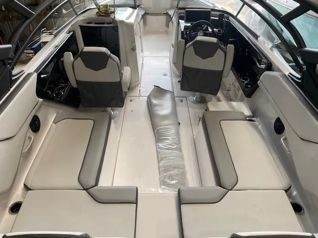 Slide: The Image of 2025 Yamaha Boats AR250 interior with sleek seating and modern dashboard design. - 2