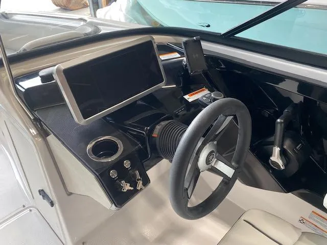 Slide: The Image of 2025 Yamaha Boats AR250 dashboard with steering wheel, touchscreen, and controls. - 5