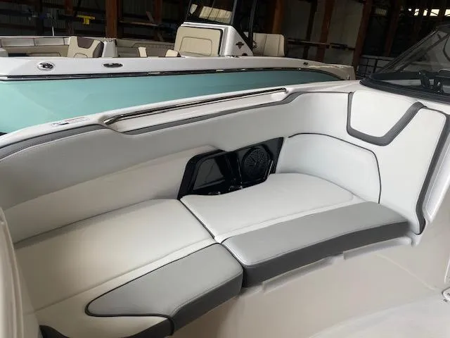 Slide: The Image of 2025 Yamaha AR250 boat interior with sleek white and gray seating. - 6