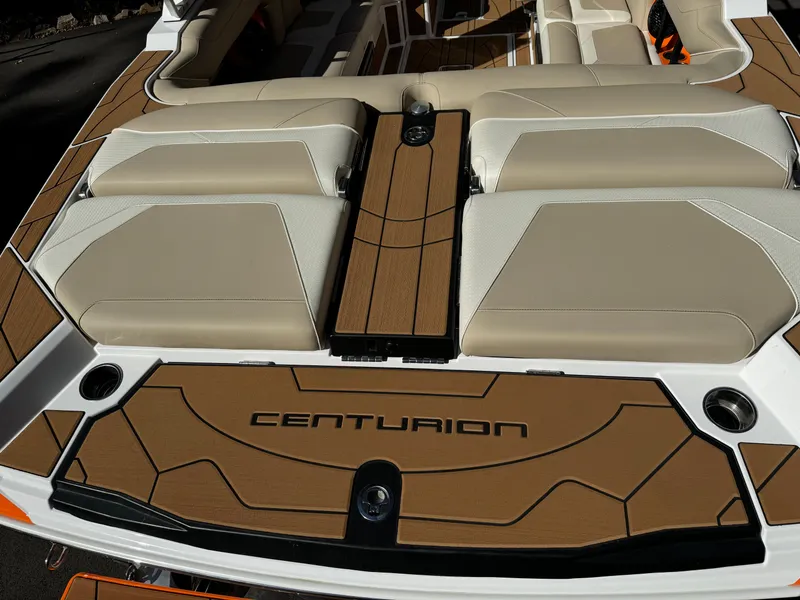 Slide: The Image of 2023 Centurion Ri230 boat interior with beige and brown seating. - 10