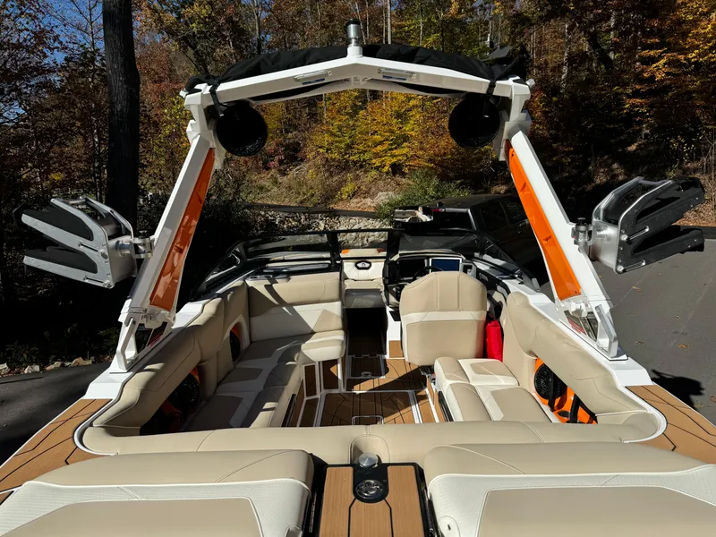Slide: The Image of 2023 Centurion Ri230 boat interior with beige seating and advanced sound system. - 17
