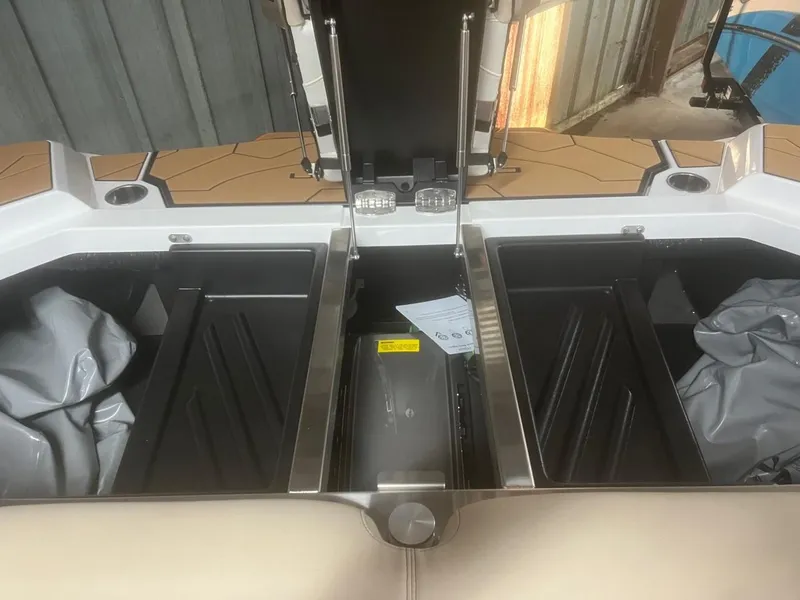 Slide: The Image of 2023 Centurion Ri230 boat storage compartments open, showcasing interior design. - 9
