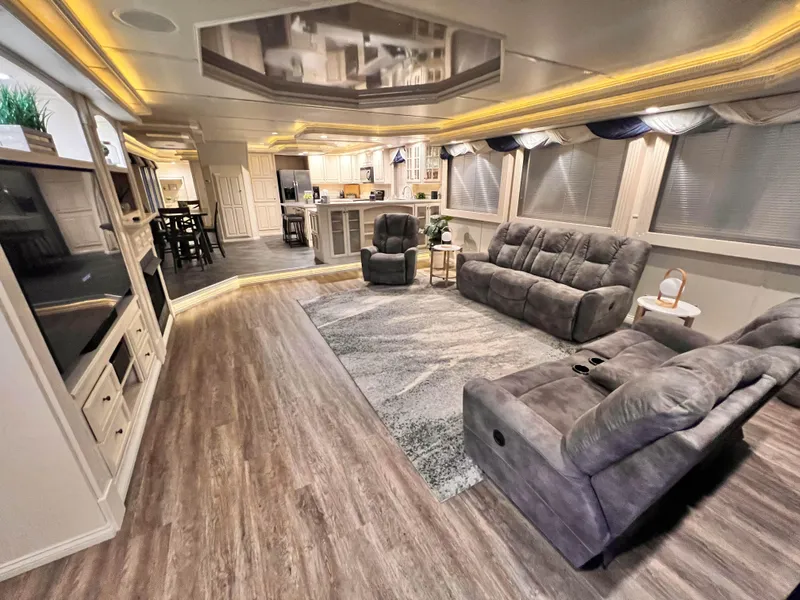 Slide: The Image of Luxurious 2002 Thoroughbred 99 x 20 RV interior with plush seating and modern kitchen. - 14