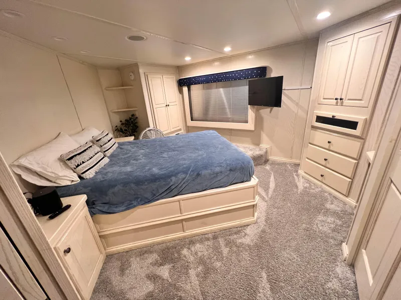 Slide: The Image of Spacious bedroom in 2002 Thoroughbred 99 x 20 RV with cozy bed and modern decor. - 18