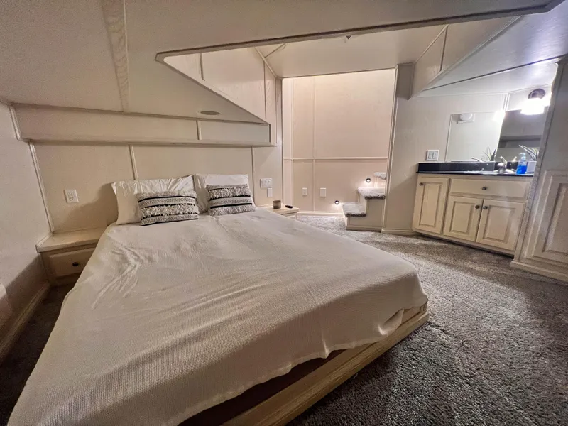 Slide: The Image of Cozy bedroom in 2002 Thoroughbred 99 x 20 RV with bed and vanity area. - 19