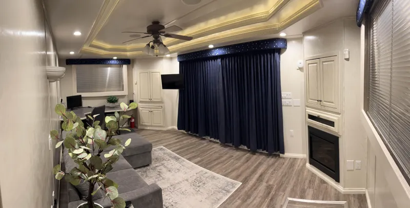 Slide: The Image of Luxurious RV interior with modern decor, blue curtains, and wood flooring. - 22