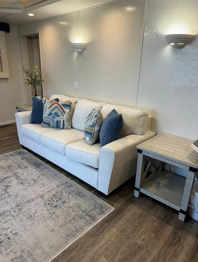 Slide: The Image of Modern living room with white sofa, decorative pillows, and stylish lighting in a Thoroughbred 99 x 20. - 23