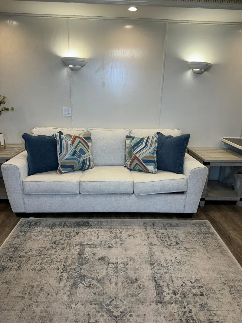 Slide: The Image of Modern living room with a light gray sofa, colorful pillows, and a patterned rug. - 25