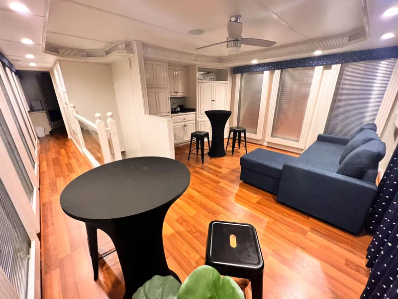 Slide: The Image of Spacious Thoroughbred 99 x 20 houseboat interior with modern kitchen and cozy seating, 2002 model. - 26