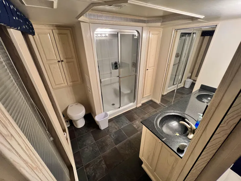 Slide: The Image of Luxurious bathroom in 2002 Thoroughbred 99 x 20 RV with shower and vanity. - 29