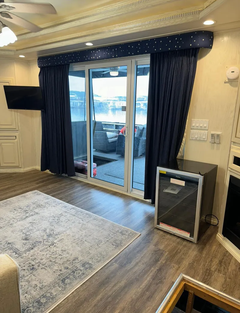 Slide: The Image of Interior of 2002 Thoroughbred 99 x 20 houseboat with modern decor and lake view. - 32