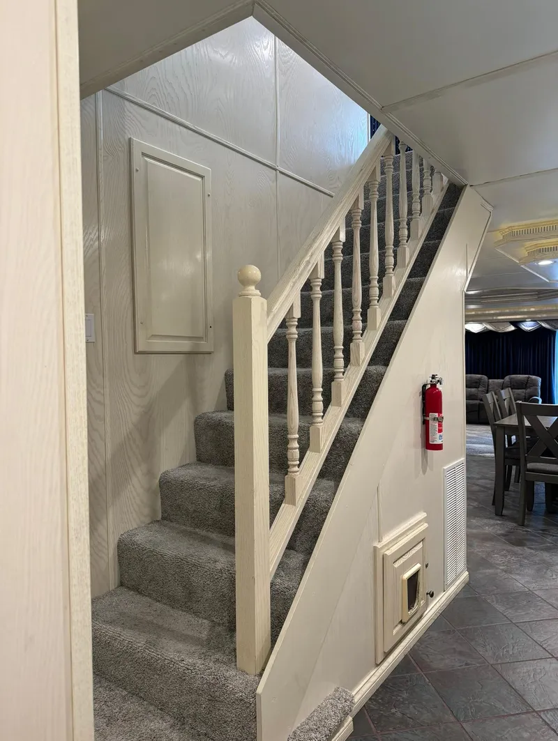 Slide: The Image of Carpeted staircase in a 2002 Thoroughbred 99 x 20 model interior. - 37