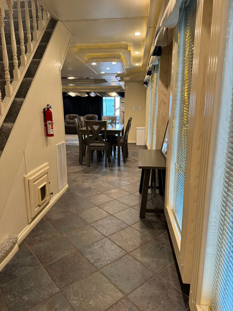 Slide: The Image of Interior of a 2002 Thoroughbred 99 x 20, featuring a dining area and staircase. - 39