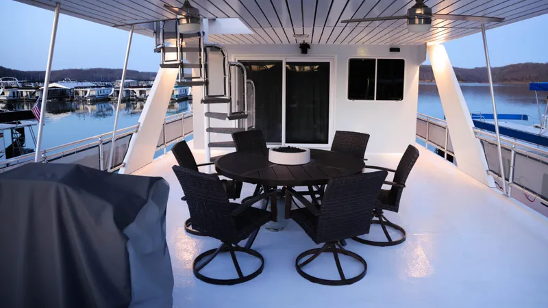 Slide: The Image of Spacious deck of 2002 Thoroughbred 99 x 20 houseboat with outdoor seating and scenic view. - 4