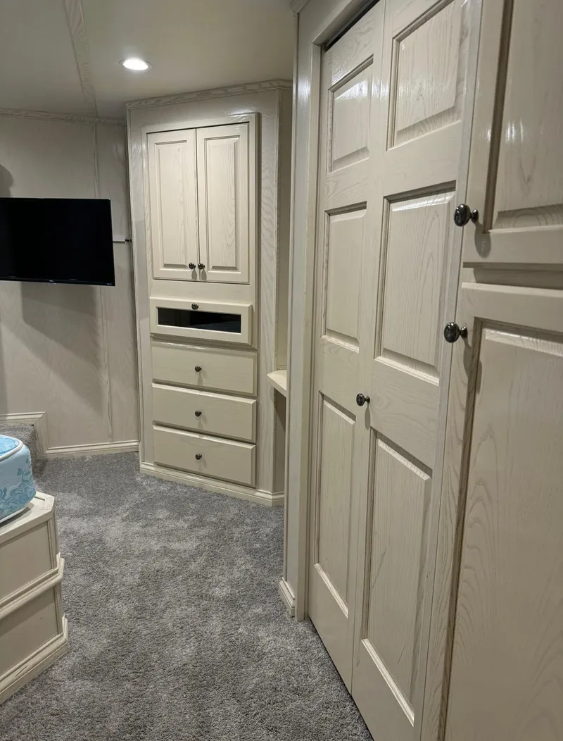 Slide: The Image of Interior of 2002 Thoroughbred 99 x 20 RV with beige cabinets and carpet. - 40