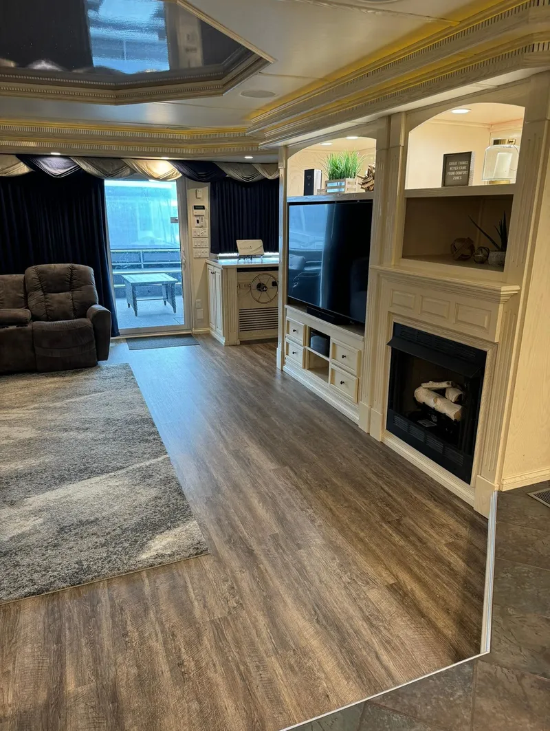 Slide: The Image of Luxurious 2002 Thoroughbred 99 x 20 RV interior with modern living area and fireplace. - 42