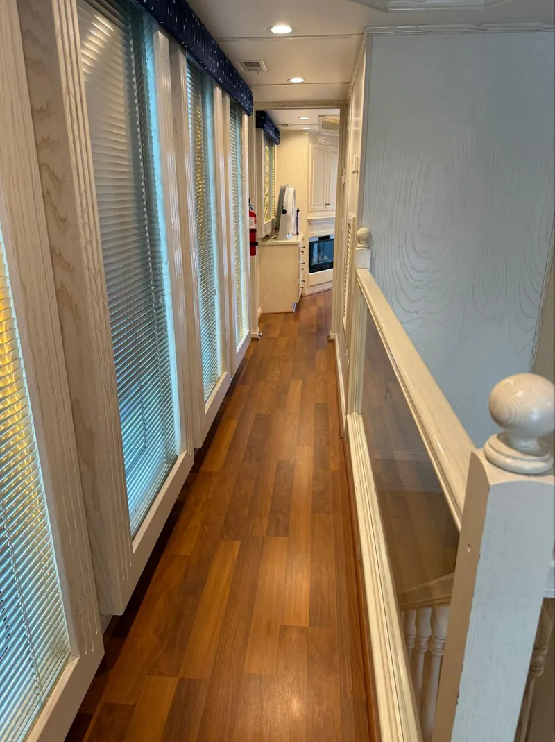 Slide: The Image of Interior hallway of 2002 Thoroughbred 99 x 20, featuring wood flooring and large windows. - 45