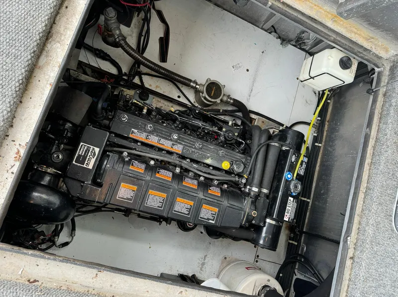 Slide: The Image of Engine compartment of a 2002 Thoroughbred 99 x 20 boat, showcasing detailed mechanical components. - 46