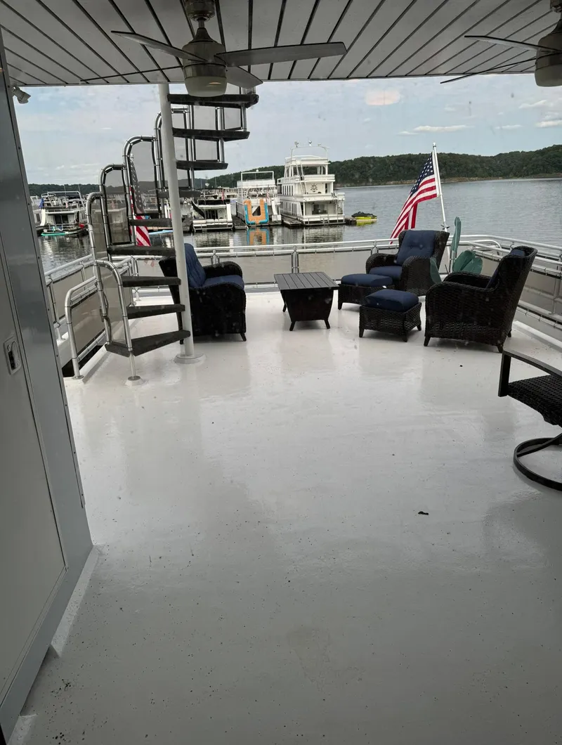 Slide: The Image of Spacious deck of 2002 Thoroughbred 99 x 20 houseboat with seating and spiral staircase. - 8