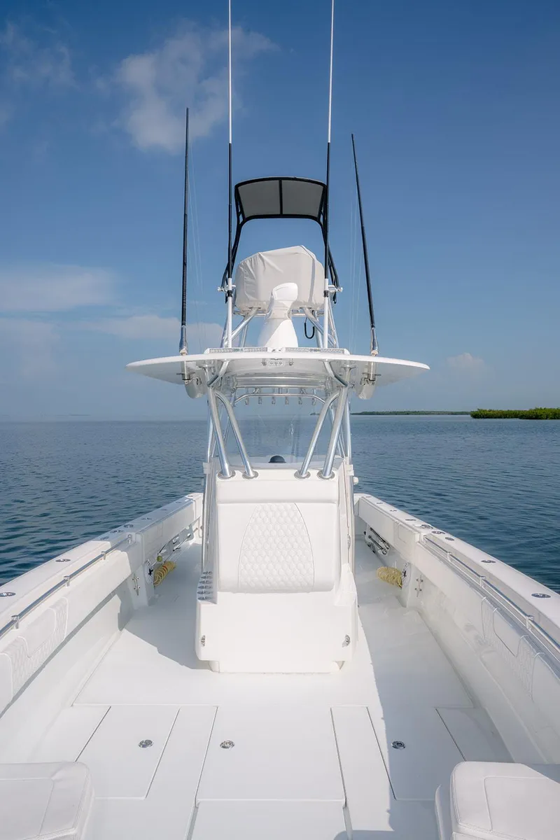 Slide: The Image of 2022 Contender 39 ST boat on calm water, showcasing spacious deck and seating. - 18